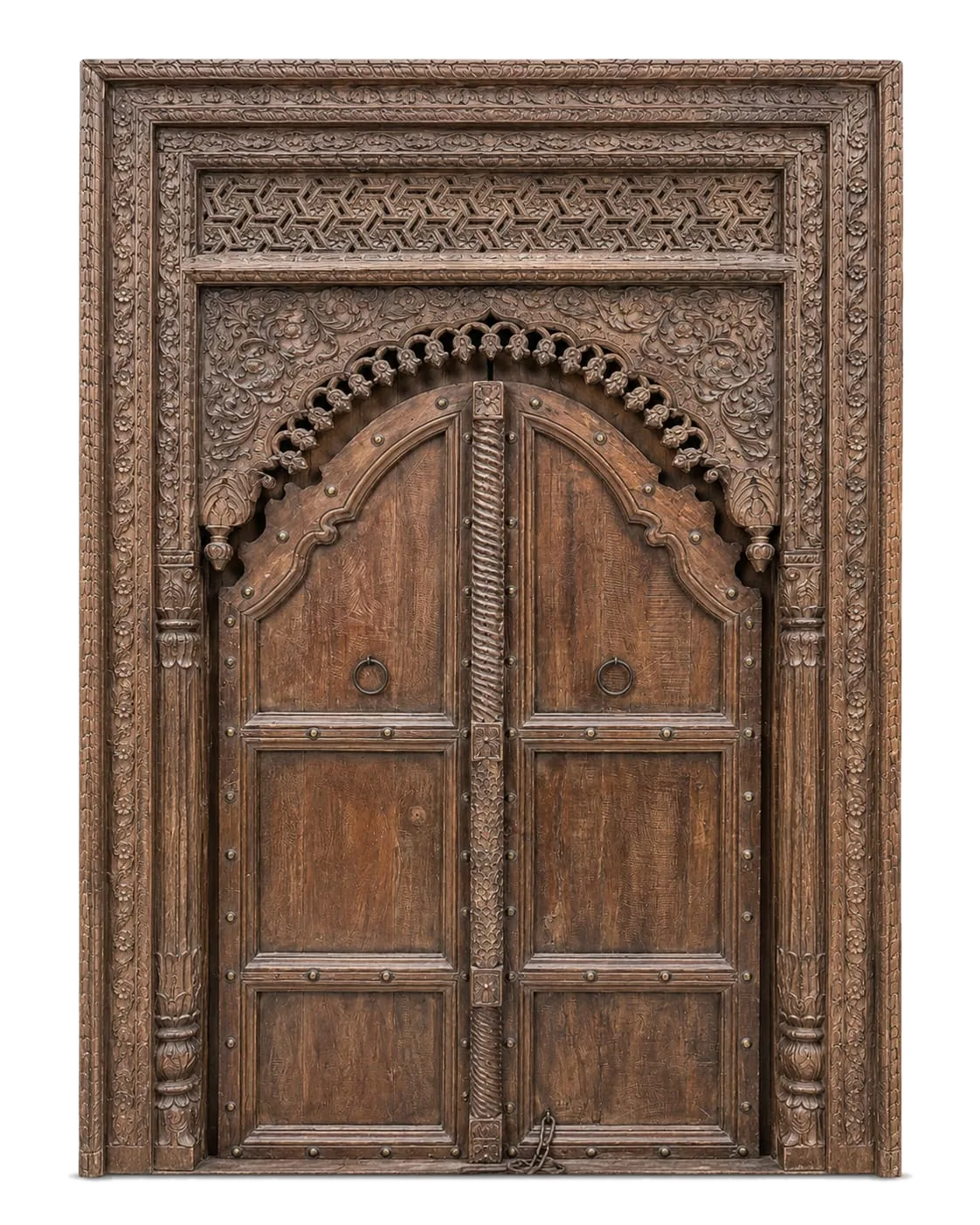 A hand-carved Indian door with jali screen and brass studs